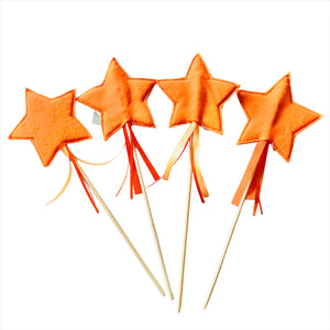 felt star fairy wand on bamboo sticks with ribbon hanging under the star.  Orange